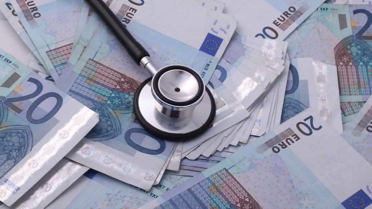 silver and black stethoscope on 100 indian rupee bill